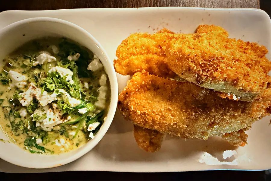 Crumbed schnitzel with creamed spinach
